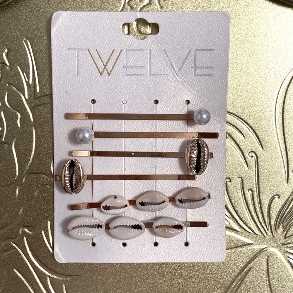 6 brand new hair pins with pearls and shells.